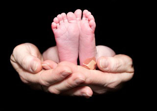 Holding baby's feet- image by Heidi Sharpe